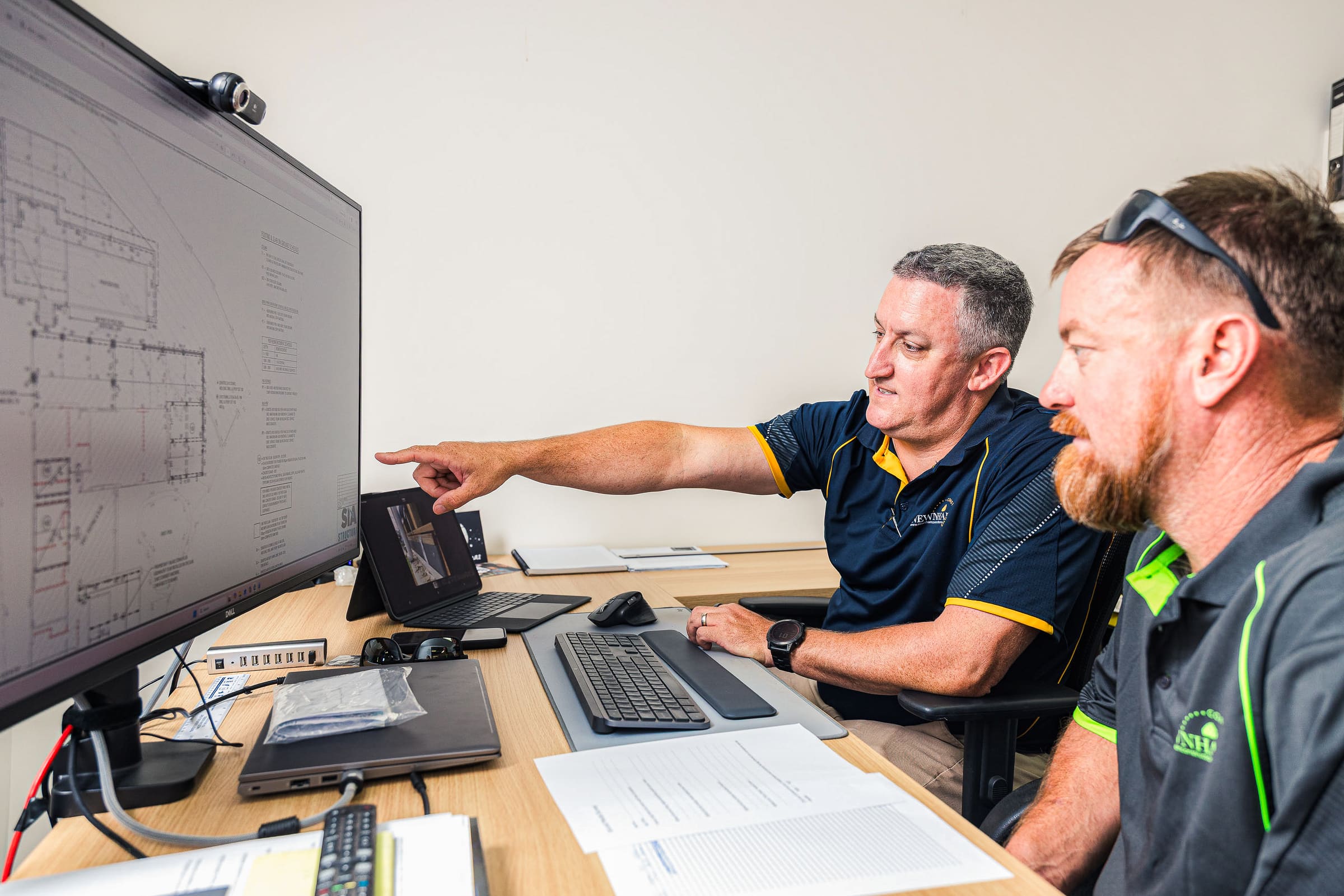 Newnham Constructions team reviewing building plans on screen