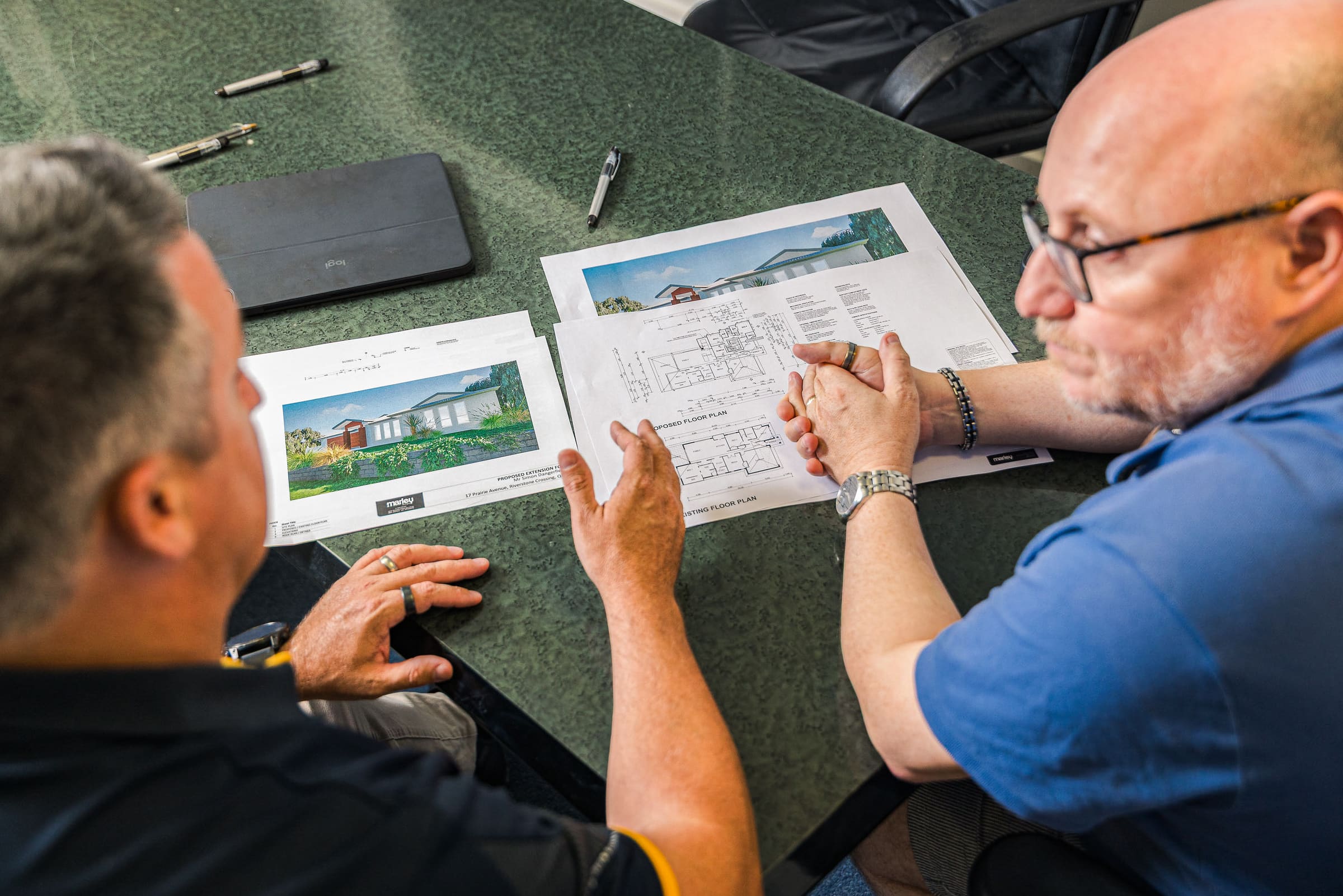 Newnham Constructions builder reviewing plans with a client
